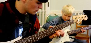 Student plays bass guitar - Portland Conservatory of Music