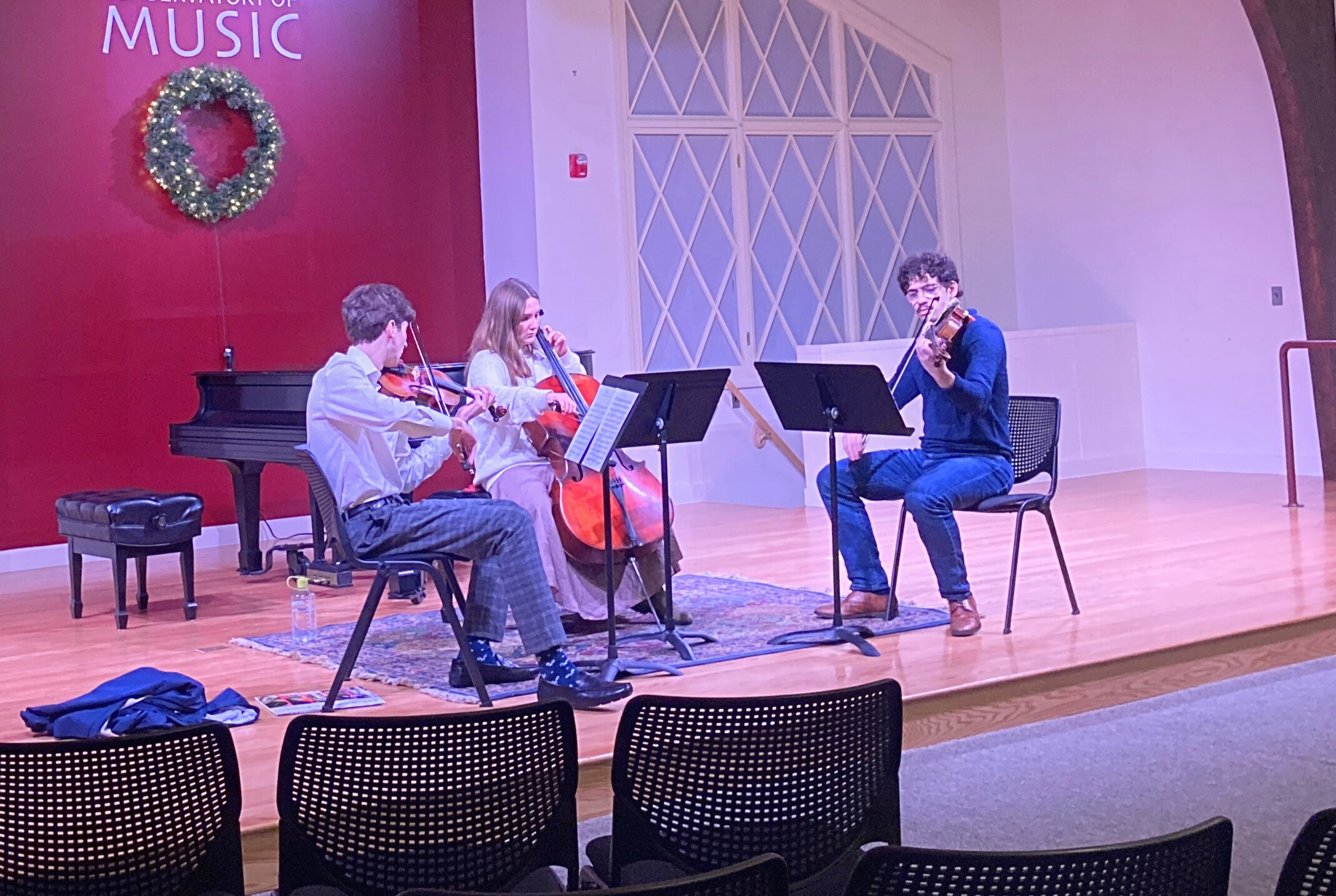 Student string trio performing on stage